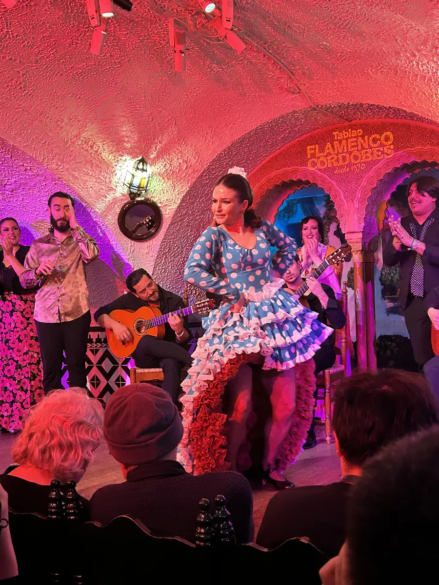 Flamenco dancer in a ruffled dress performing at Tablao Flamenco Cordobés