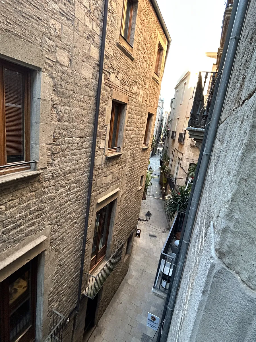 Looking down a narrow stone street in the Gothic Quarter of Barcelona