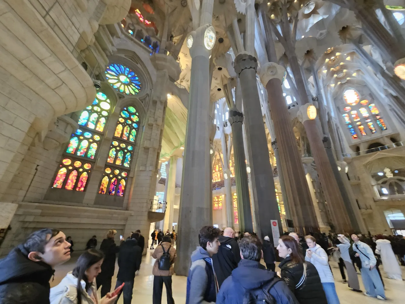 Stained glass windows and towering columns inside the Sagrada Família