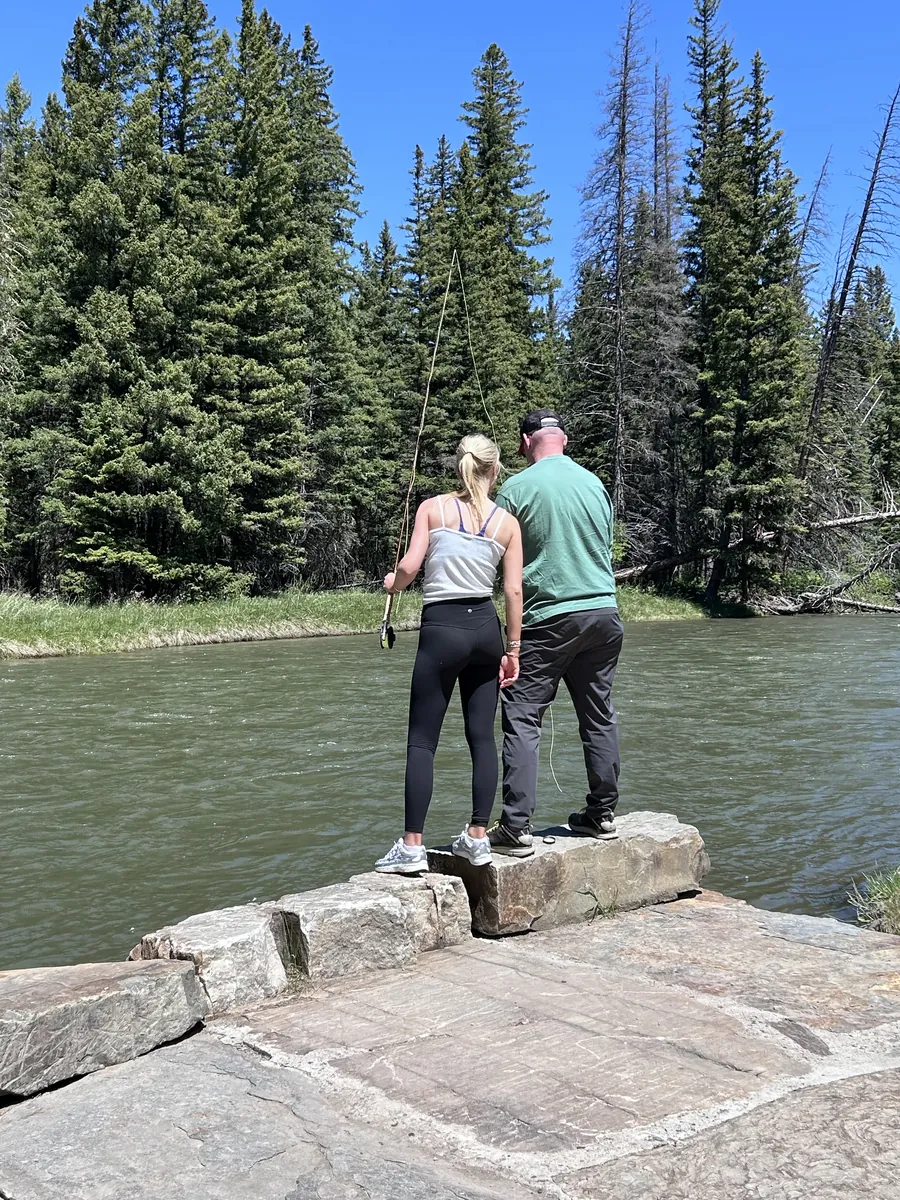 Father showing his daughter how to fly cast on the Gallatin River