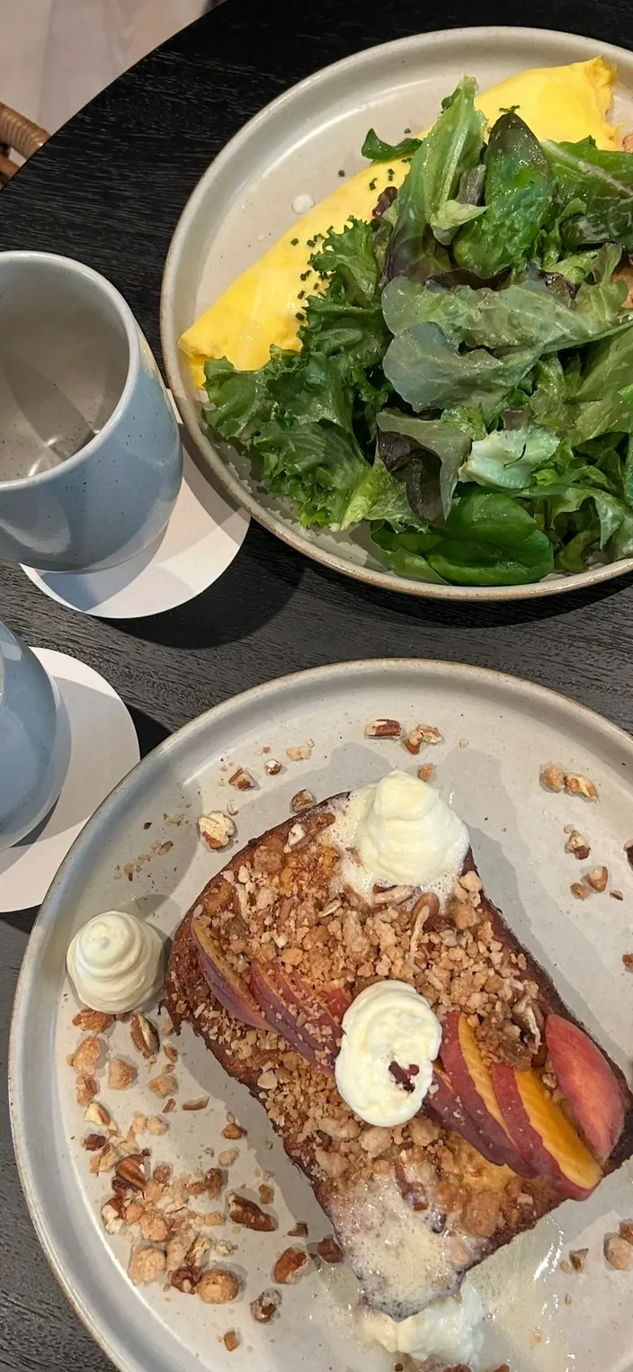 Farm-fresh breakfast at January restaurant — peach French toast with whipped cream and a perfect omelet with greens