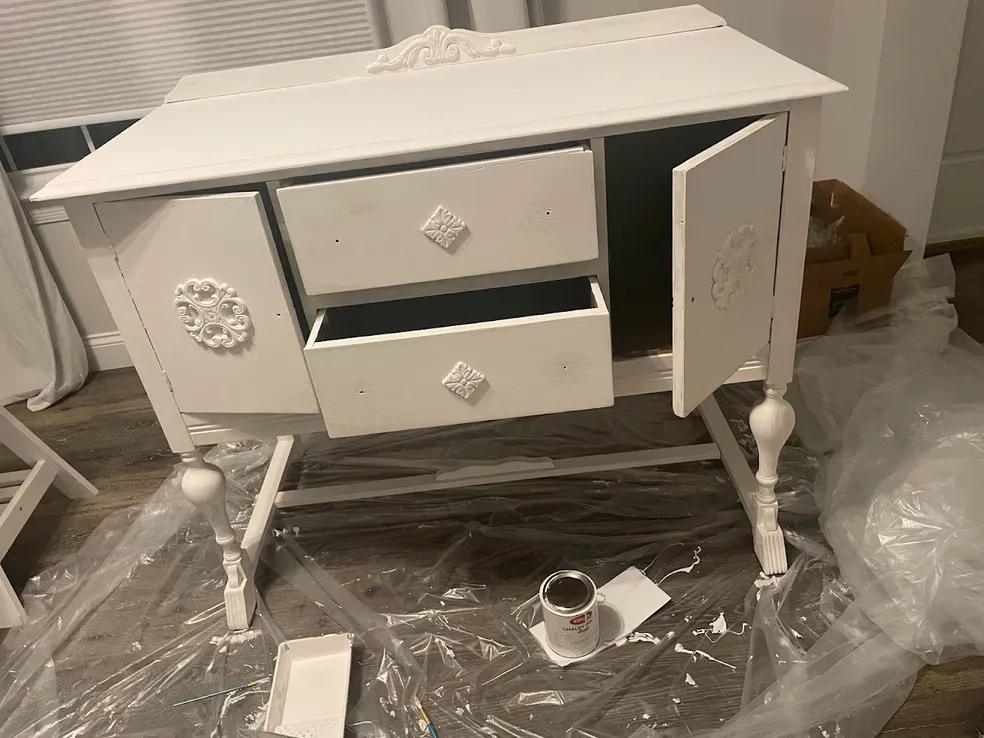 The cake table painted white with chalk paint — a Facebook Marketplace find transformed