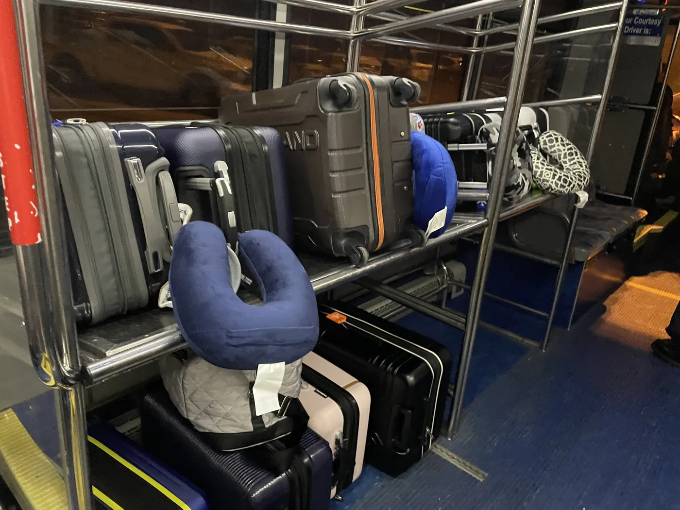 Airport luggage cart piled with family suitcases