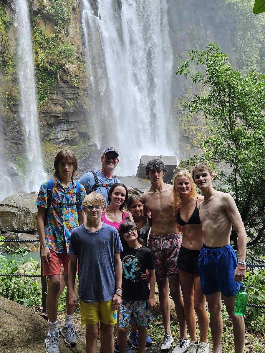 Family in swimsuits after swimming at Nauyaca Waterfalls
