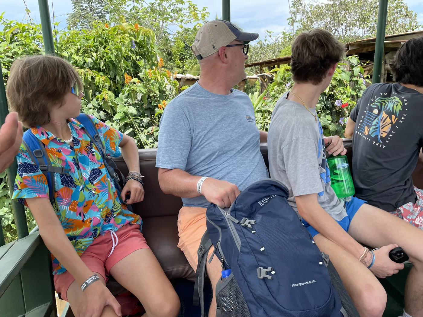 Family riding in an open-air truck on the way to Nauyaca Waterfalls