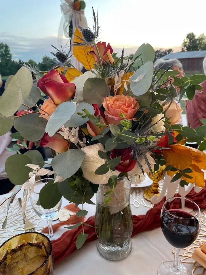 Fresh flower centerpiece with roses, eucalyptus, and fall blooms
