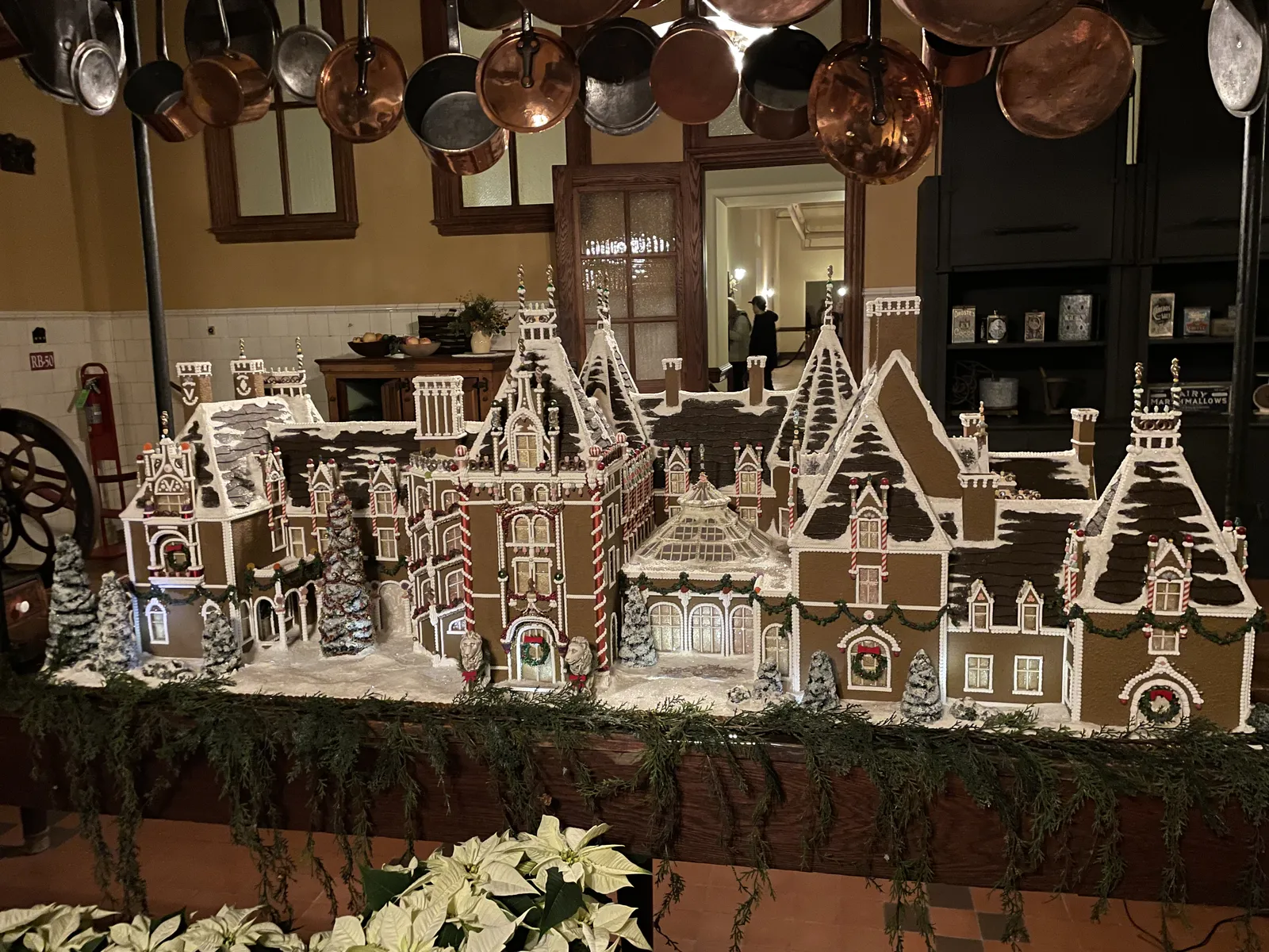 A detailed gingerbread village with houses, a church and snowy rooftops on display