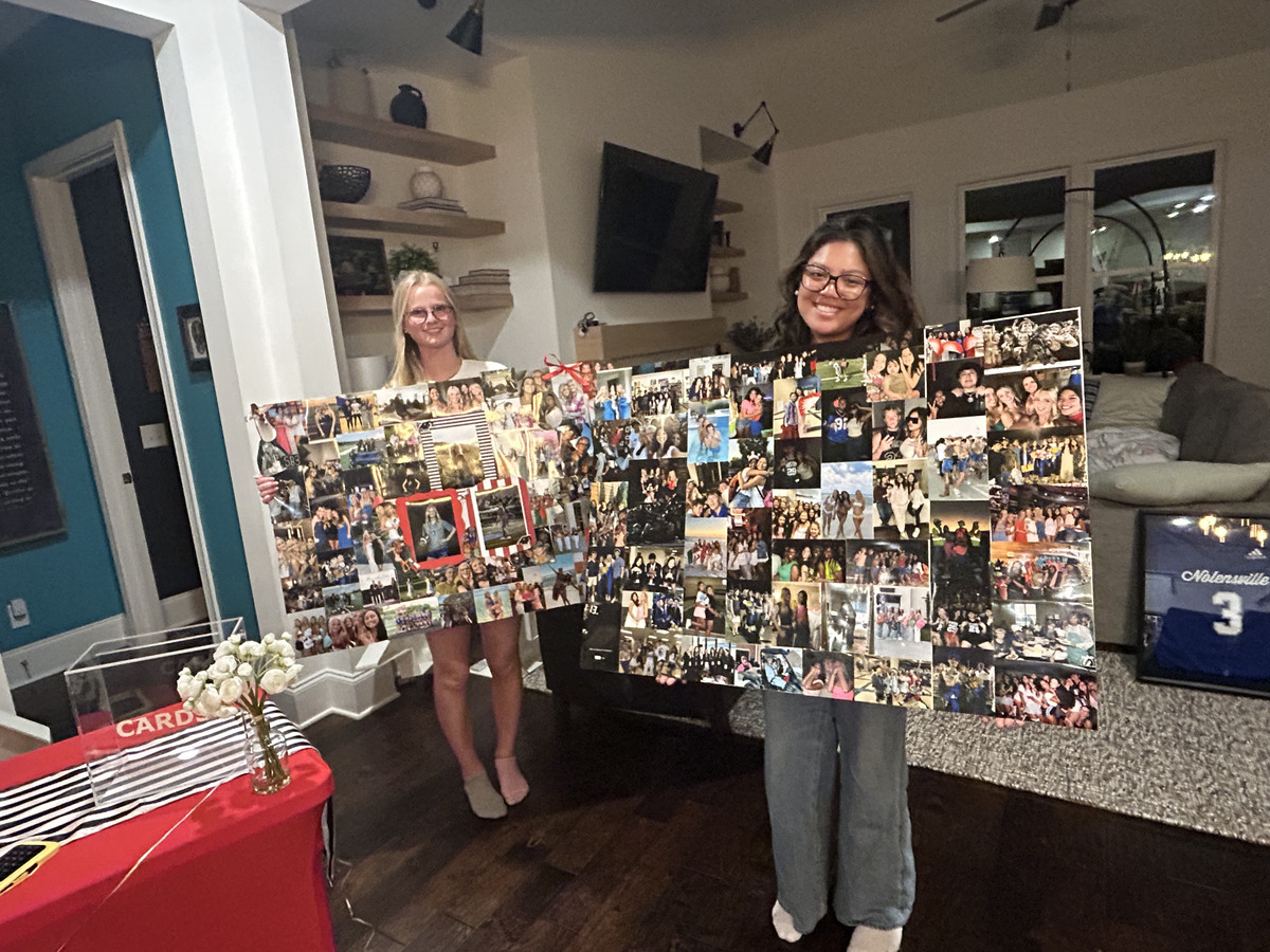 Sarah and Ivy each holding one of their finished photo collage boards the night before the party
