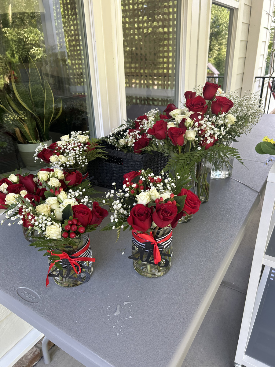 All the mason jar centerpieces lined up on a prep table the morning of the party