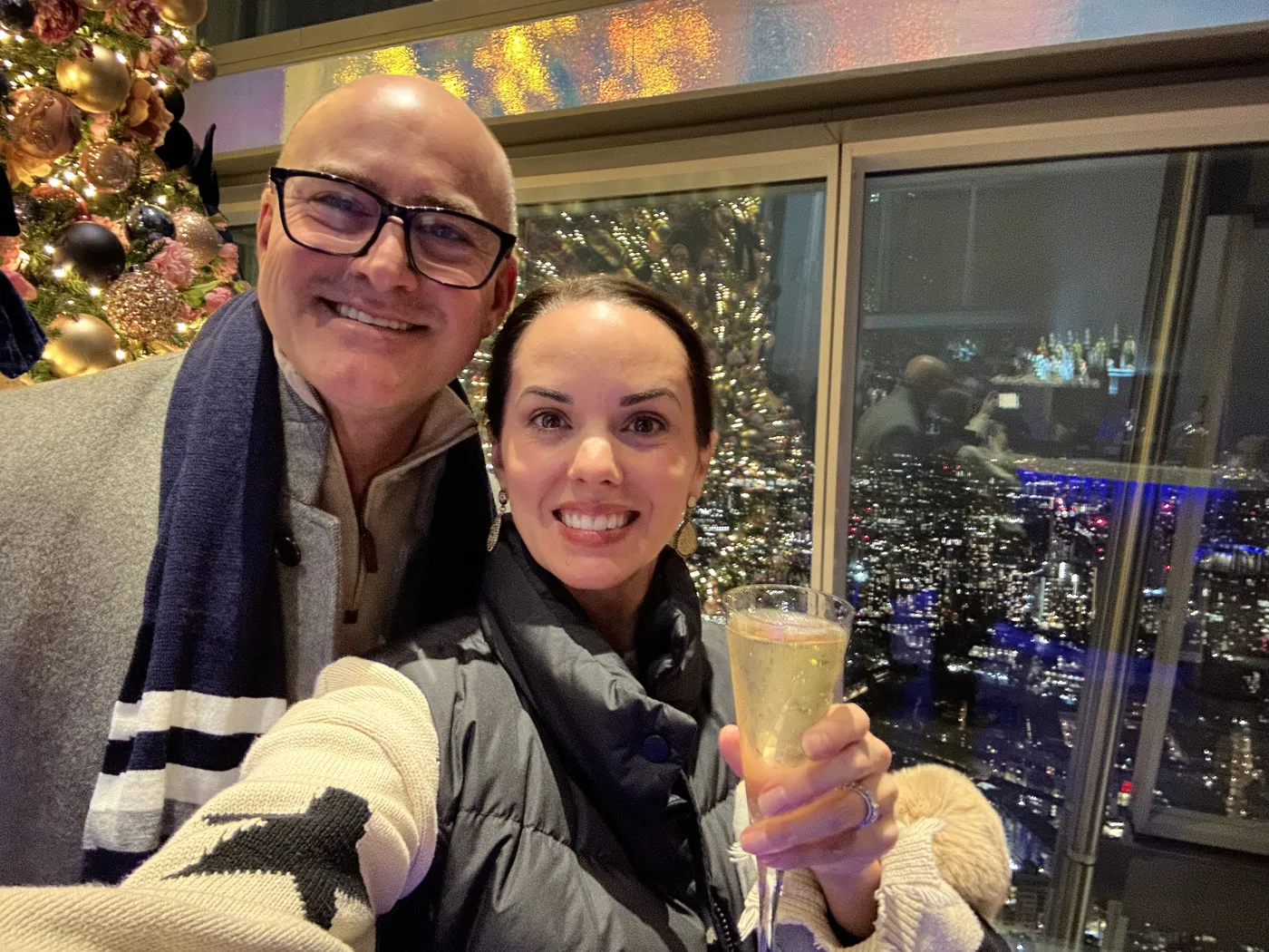 Jason and Heather toasting with champagne at the top of the Shard