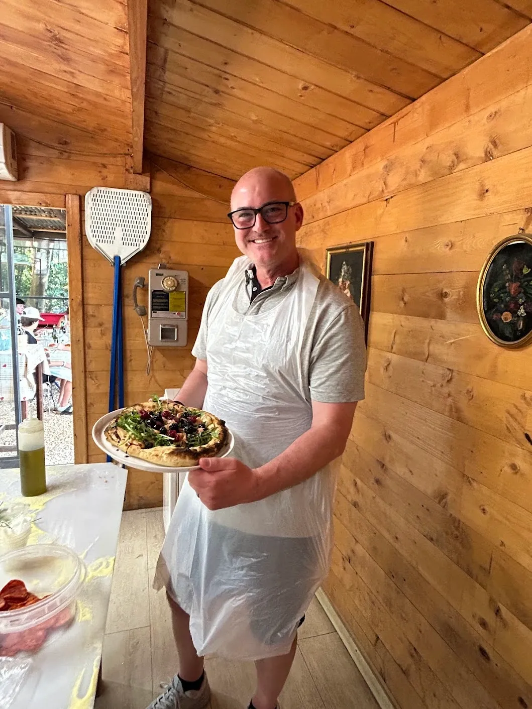 Jason proudly showing off his pizza at Chef Giuseppe's class